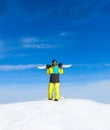 Snowboarder hold snowboard on top of hill