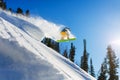 Snowboarder at jump inhigh mountains at sunny day. Royalty Free Stock Photo