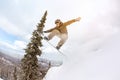 Snowboarder jump offpiste forest freeride