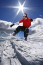 Snowboarder jumping against blue sky Royalty Free Stock Photo