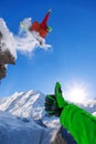 Snowboarder jumping against blue sky in high mountains Royalty Free Stock Photo