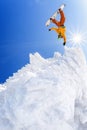 Snowboarder jumping against blue sky in high mountains Royalty Free Stock Photo