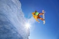 Snowboarder jumping against blue sky Royalty Free Stock Photo