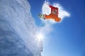 Snowboarder jumping against blue sky Royalty Free Stock Photo