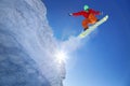 Snowboarder jumping against blue sky