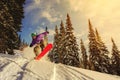 Snowboarder jumping through air with deep blue sky in background Royalty Free Stock Photo