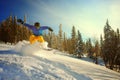 Snowboarder jumping through air with deep blue sky in background Royalty Free Stock Photo