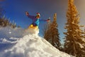 Snowboarder jumping through air with deep blue sky in background Royalty Free Stock Photo