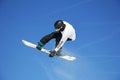 Snowboarder jumping through air with sky in background Royalty Free Stock Photo