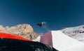 Snowboarder jumping on kicker, balloon landing, Val di Fassa Dolomiti snow park