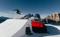 Snowboarder jumping on kicker, balloon landing, Val di Fassa Dolomiti snow park