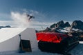 Snowboarder jumping on kicker, balloon landing, Val di Fassa Dolomiti snow park