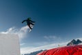 Snowboarder jumping on kicker, balloon landing, Val di Fassa Dolomiti snow park