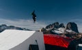 Snowboarder jumping on kicker, balloon landing, Val di Fassa Dolomiti snow park