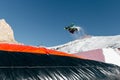 Snowboarder jumping on kicker, balloon landing, Val di Fassa Dolomiti snow park