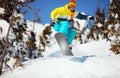 Snowboarder jumping on mountain slope