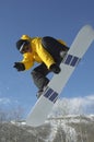 Snowboarder In Jumping While Showing Victory Sign Against Sky Royalty Free Stock Photo