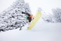 Snowboarder jumping on ski slope