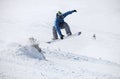 Snowboarder jumping on a snowy slope