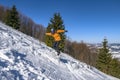 Snowboarder jumps from snow hill. Mountain freeride snowboarding. Winter mountains Carpathians