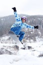 Snowboarder jumps on snowboard