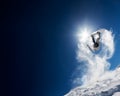 Snowboarder making high jump in clear blue sky Royalty Free Stock Photo