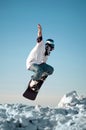 Snowboarder making jump against the sky Royalty Free Stock Photo