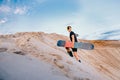 Snowboarder man sand boarding on dunes in Dubai, UAE Royalty Free Stock Photo