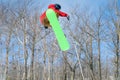 A snowboarder performs a mid-air trick in a terrain park