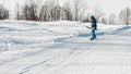 Snowboarder performs a nollie frontside 180 trick while climbing on a T-bar lift