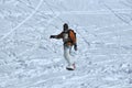 Snowboarder in powder snow with walkie-talkie