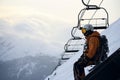 Snowboarder prepares for descent beneath a cable car route