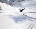 Snowboarder racing down