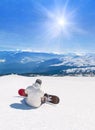 Snowboarder relaxing against mountains in sun rays, winter sports holidays travel at ski health resort concept Royalty Free Stock Photo
