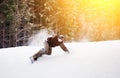 Snowboarder rides over fresh snow on the slope in winter