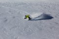 Snowboarder riding deep powder snow