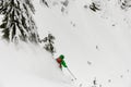 Snowboarder riding down in avalanche track terrain during as part of fun, extreme, splitboard Royalty Free Stock Photo