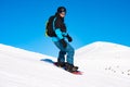 Snowboarder Riding Red Snowboard in Mountains at Sunny Day. Snowboarding and Winter Sports Royalty Free Stock Photo