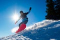 Snowboarder Riding Red Snowboard in Mountains at Sunny Day. Snowboarding and Winter Sports Royalty Free Stock Photo