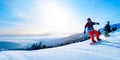 Snowboarder Riding Red Snowboard in Mountains at Sunny Day. Snowboarding and Winter Sports Royalty Free Stock Photo