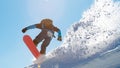 Snowboarder Riding Red Snowboard in Mountains at Sunny Day. Snowboarding and Winter Sports Royalty Free Stock Photo