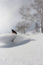 Snowboarder ripping into the fresh snow