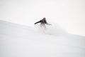 Snowboarder roundly descends from the mountain in freeride style