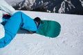Snowboarder sit on slope wile snowboarding Royalty Free Stock Photo