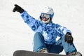 Snowboarder sits on snowy hillside