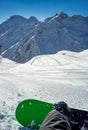 Snowboarder sitting resting on track