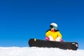 Snowboarder sitting snow mountain slope copy space Royalty Free Stock Photo