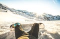 Snowboarder sitting at sunset on relax moment in european alps s