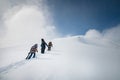 snowboarder and skier go uphill carrying equipment. off-piste skiing, freeride on a sunny day Royalty Free Stock Photo