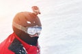 Snowboarder or skier portrait in sport goggles and protection helmet with mounted action camera and ski slope on background. Royalty Free Stock Photo